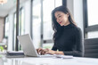 © Charlie's - Beautiful confident asian business woman working with laptop Hands typing  keyboard. Professional investor working new start up project. business planning in office. Technology business