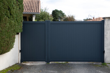 Wall Mural - Aluminum gray high modern grey portal closed of suburb garden with pedestrian door house