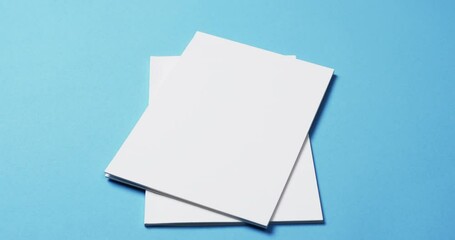 Canvas Print - Video of books with white blank pages and copy space on blue background