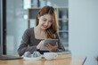 © SOMKID - young asian woman and online education at desk.