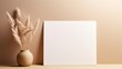  3D background presenting white paper, an empty blank canvas, and dried grass decoration against a calming beige background. The invitation card mockup graces a beige table in a flat lay,
