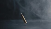 Bullet Casing Descending With Swirling Smoke In Background