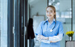 © SOMKID - Asian female doctor Standing with arms crossed at hospital, Medicine and healthcare concept.