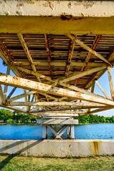 Canvas Print - Under suspension bridge with lake in public park