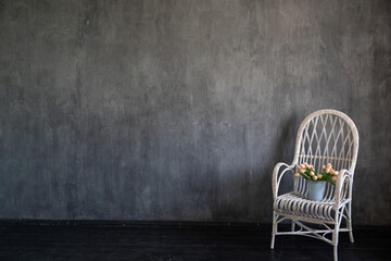 Canvas Print - Vintage armchair with flowers in grey room interior