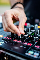 Wall Mural - DJ Hands creating and regulating music on dj console mixer in concert