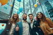 © Bojan - Group of young business people and colleagues having fun together at celebration of a successful target near company office building. Confetti and balloons enjoyment.