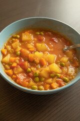 Wall Mural - Homemade vegetable soup close up view of vegan healthy soup in a bowl