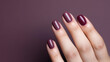 Woman hand with burgundy color nail polish on her fingernails. Burgundy nail manicure with gel polish at luxury beauty salon. Nail art and design. Female hand model. French manicure. Generative AI.
