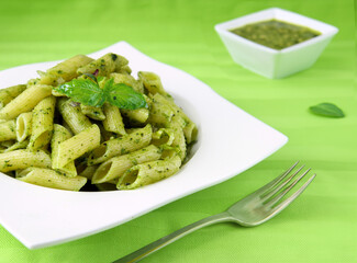 Wall Mural - penne pasta with pesto and basil