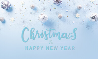 Wall Mural - Christmas and new year background concept. Top view of Christmas ball, star and snowflake on pastel blue background.