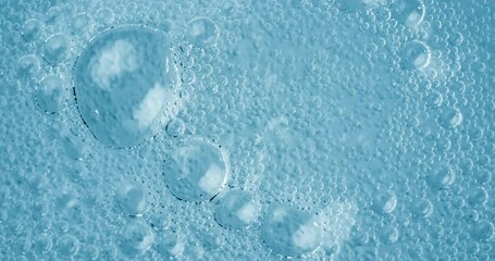 Wall Mural - Oxygen bubbles in water on a blue abstract background on super slow motion.