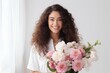 © BajimBa - Portrait of a happy smiling woman with a bouquet of flowers in her hands.
