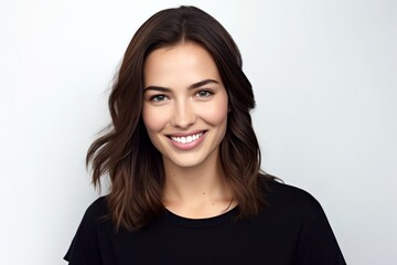 Wall Mural - close-up portrait of cute beautiful natural brunette woman in black t-shirt, smiling and looking in camera, isolated on white background