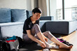 © Davor - Woman preparing for home workout in living room