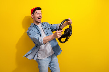 Sticker - Photo of impressed funky guy wear denim jacket driving car empty space isolated yellow color background