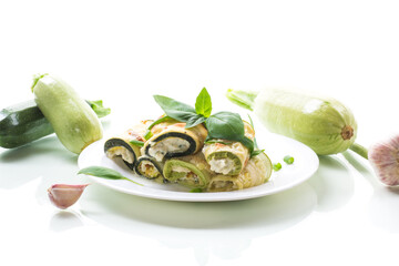 Wall Mural - cooked zucchini rolls with cheese filling inside, in a plate