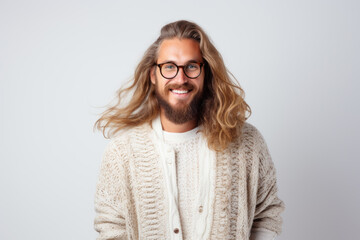 Wall Mural - Portrait of a handsome European male model wearing prescription glasses and Norwegian knitted cardigan, studio shot