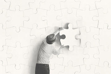 Illustration of man placing the last piece of puzzle surreal business concept