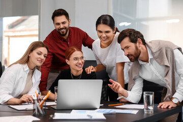 Wall Mural - Team of employees working together in office