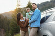 © New Africa - Parents and their daughter near car in mountains. Family traveling
