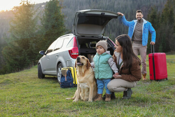 Canvas Print - Mother with her daughter, dog and man near car in mountains. Family traveling with pet