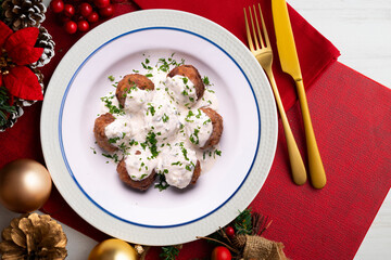 Poster - Pork meatballs with Greek tzatziki sauce with cucumber and yogurt. Christmas food on a table with decorations.