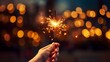 A human hand with a sparkler on a Christmas background. Christmas and New Year concept.