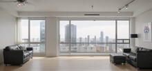 Spacious living room with leather sofas, ceiling fan, in a skyscraper, panoramic large floor-to-ceiling windows, bright room
