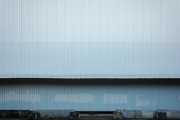 Wall Mural - Textured Corrugated Metal Siding on Industrial Building Facade of temporary construction site. 