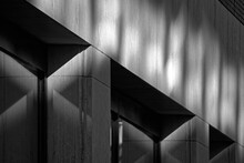 Fine art black and white monochrome photography, minimal architectural detail of diagonal support structure with light and shadow
