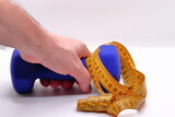Close-up of dumbbells and measuring tape for physical