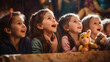 Children at an Easter-themed puppet show watching with excitement and wonder.