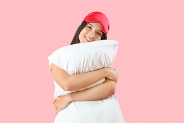 Canvas Print - Young woman with sleeping mask and pillow on pink background