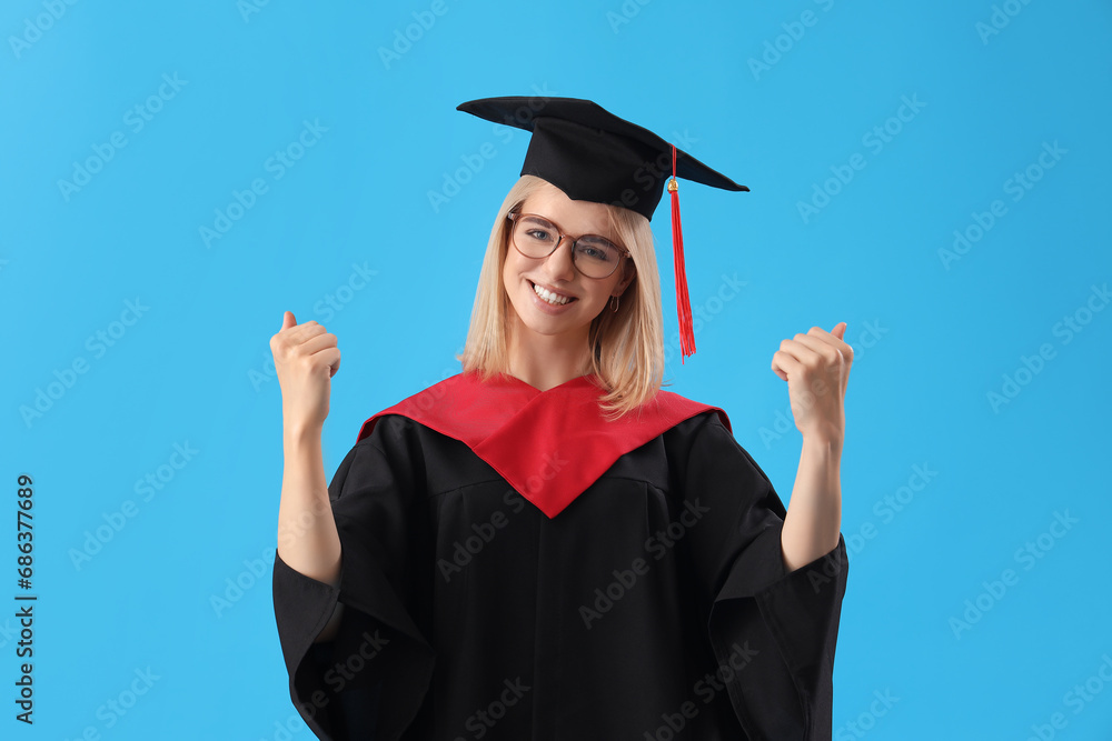Happy female graduate student on blue background