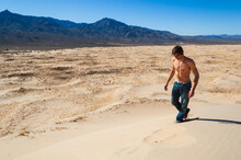A Man Walks Along The Kelso Dunes In The Mojave Desert, California