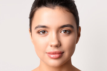 Poster - Young woman with beautiful lips on light background, closeup