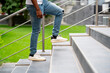 close up cropped shot of human legs going on stairs, work to success