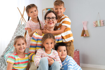 Sticker - Little children with nursery teacher in kindergarten