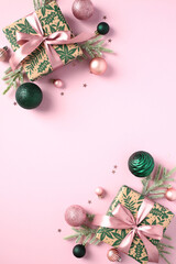 Wall Mural - Vertical Christmas pink background with gift boxes, fir branches, ball decorations, confetti. Xmas frame. Flat lay, top view, copy space. Chic, fashion style.