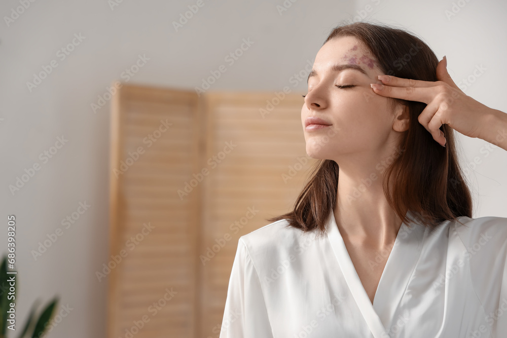 Young woman doing face building exercise in bathroom, closeup