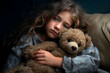 Lonely unhappy blonde baby is sad because of her parents' divorce hugging her toy teddy bear