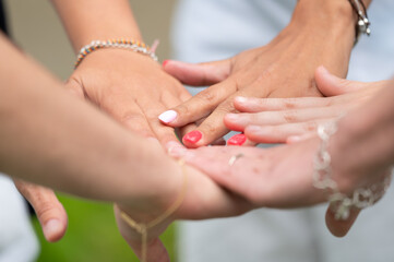 Friends, support and stack of hands of people for motivation, community and friendship outdoors. Teamwork, woman together for trust, commitment and solidarity in park. High quality photo