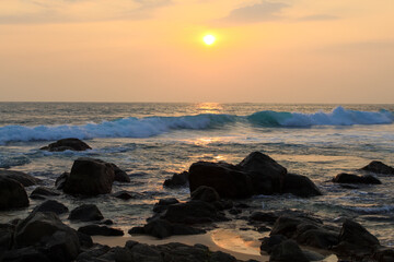 Wall Mural - Unawatuna beach in Sri Lanka. Waves crashing on the rocks