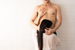 © Wongsakorn - Passionate Asian couple is having sex against white brick wall. Desire and temptation. Woman kissing man. Erotic concept. copy space for text.