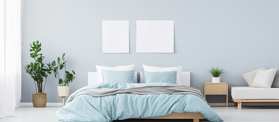 Canvas Print - Blue bed with white pillows, duvet, and duvet case. White bed linen on blue sofa. Bedroom with bed, bedding, and poster frame mock up on wall. Left side view.