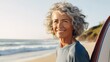 Middle-aged woman holding a surfboard on a beach, radiating vitality, optimism, health, and wellbeing, aging gracefully and embracing active lifestyle