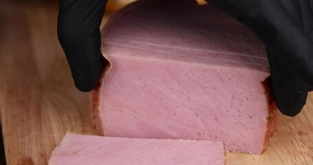 Wall Mural - sliced piece of pork ham, slicing a finished piece of ham into small pieces