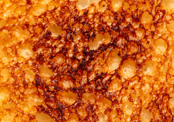 Sticker - Bread fried in a toaster as an abstract background. Macro