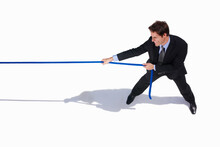 Businessman, Conflict And Tug Of War By White Background, Career Challenge And Workplace Competition. Young Person, Mental Health And Professional Worker With Rope, Top View And Job Battle In Studio